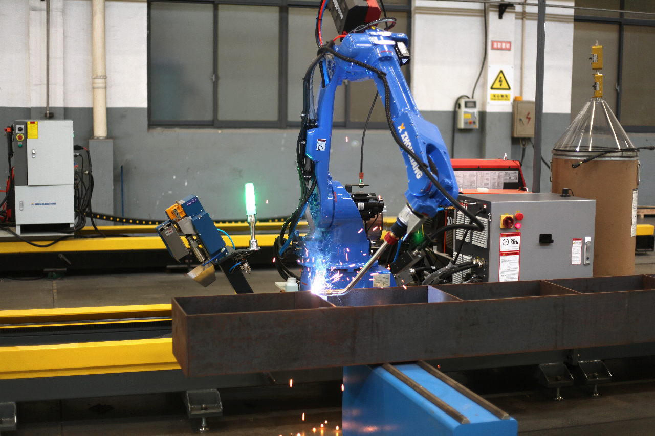 Close-up view of cantilever welding robot arm and welding torch in operation
